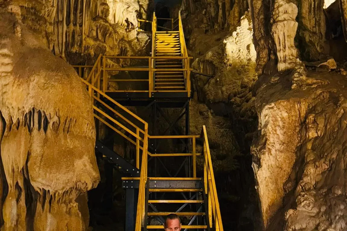Escalera amarilla entre estalactitas dentro de las Grutas de García en Nuevo León