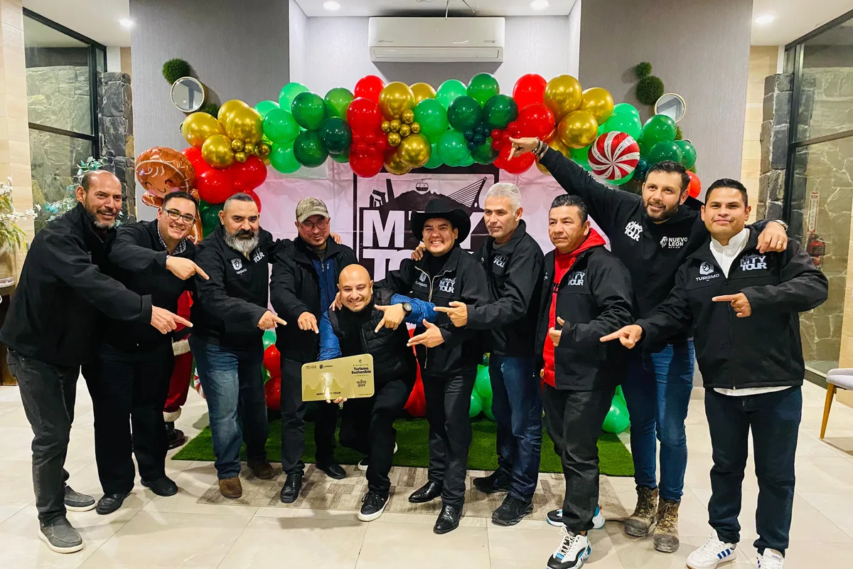 Equipo de Monterrey Tour celebra en grupo con el distintivo de Turismo Sostenible en una reunión de fin de año